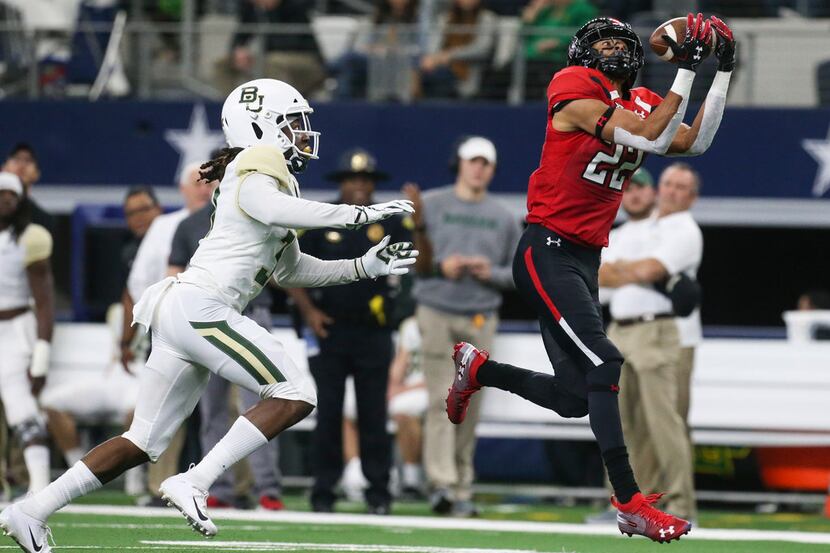 Texas Tech Red Raiders wide receiver Seth Collins (22) receives a pass over Baylor Bears...