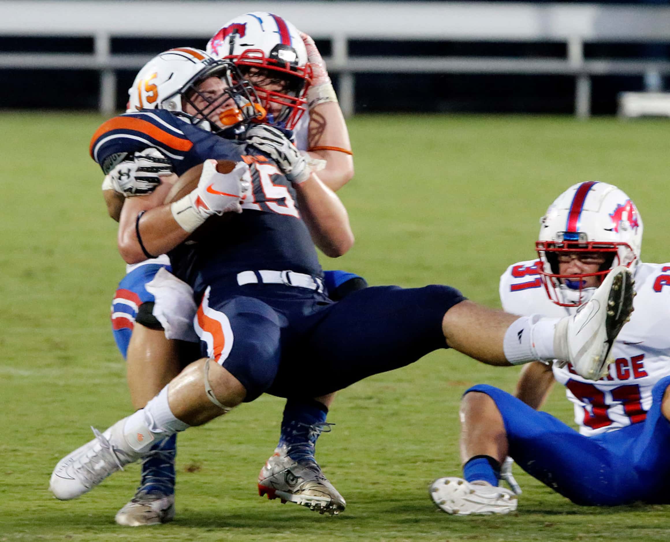 Frisco Wakeland High School tight end Chance Delashaw (15) is thrown to the ground by...