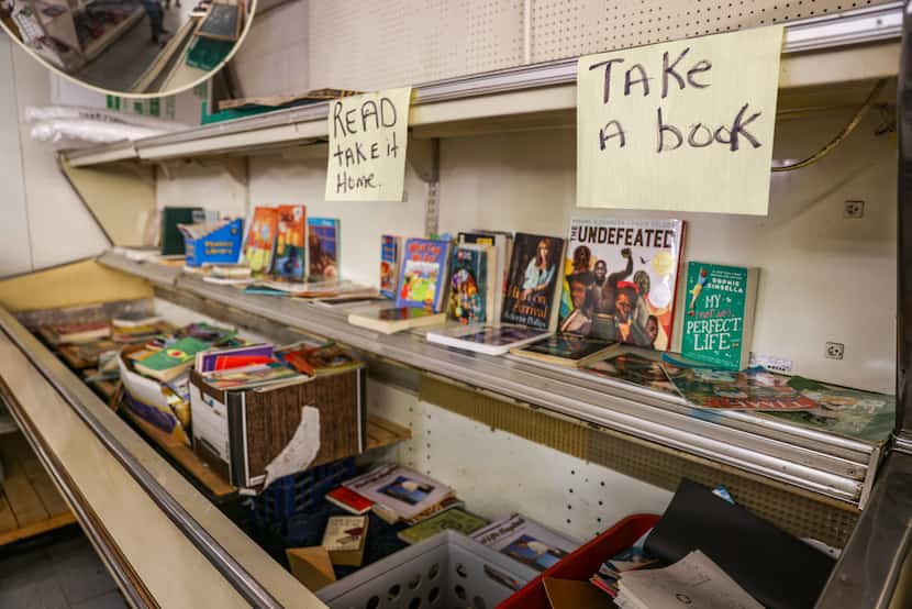 Books donated to the community rest in an old, repurposed refrigerator inside Allen’s, a...