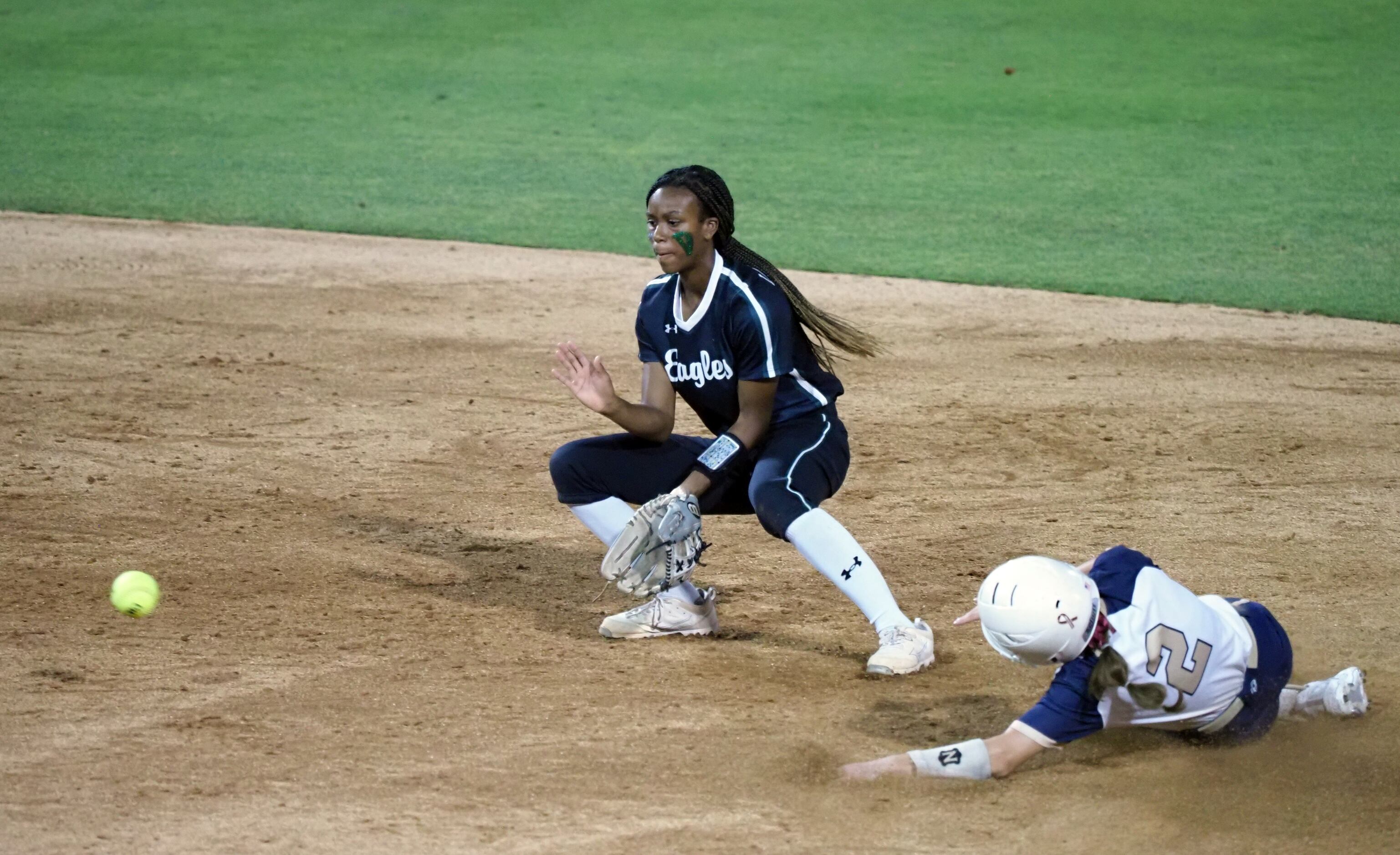 Mansfield Lake Ridge short stop Kassidy Chance 
(Left) attempts to make the play for an out...