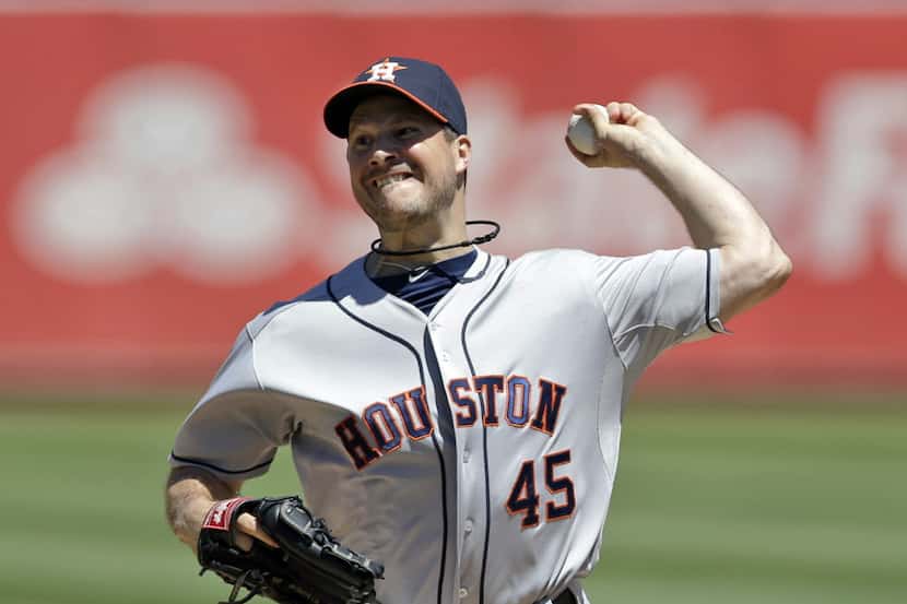 Houston Astros starting pitcher Erik Bedard throws to the Oakland Athletics during the first...