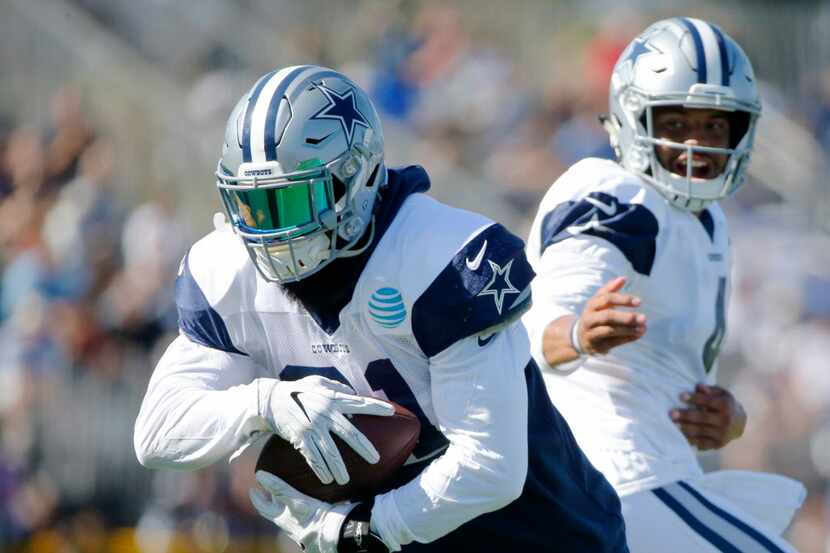 Dallas Cowboys quarterback Dak Prescott (4) watches after he hands the ball off to Dallas...