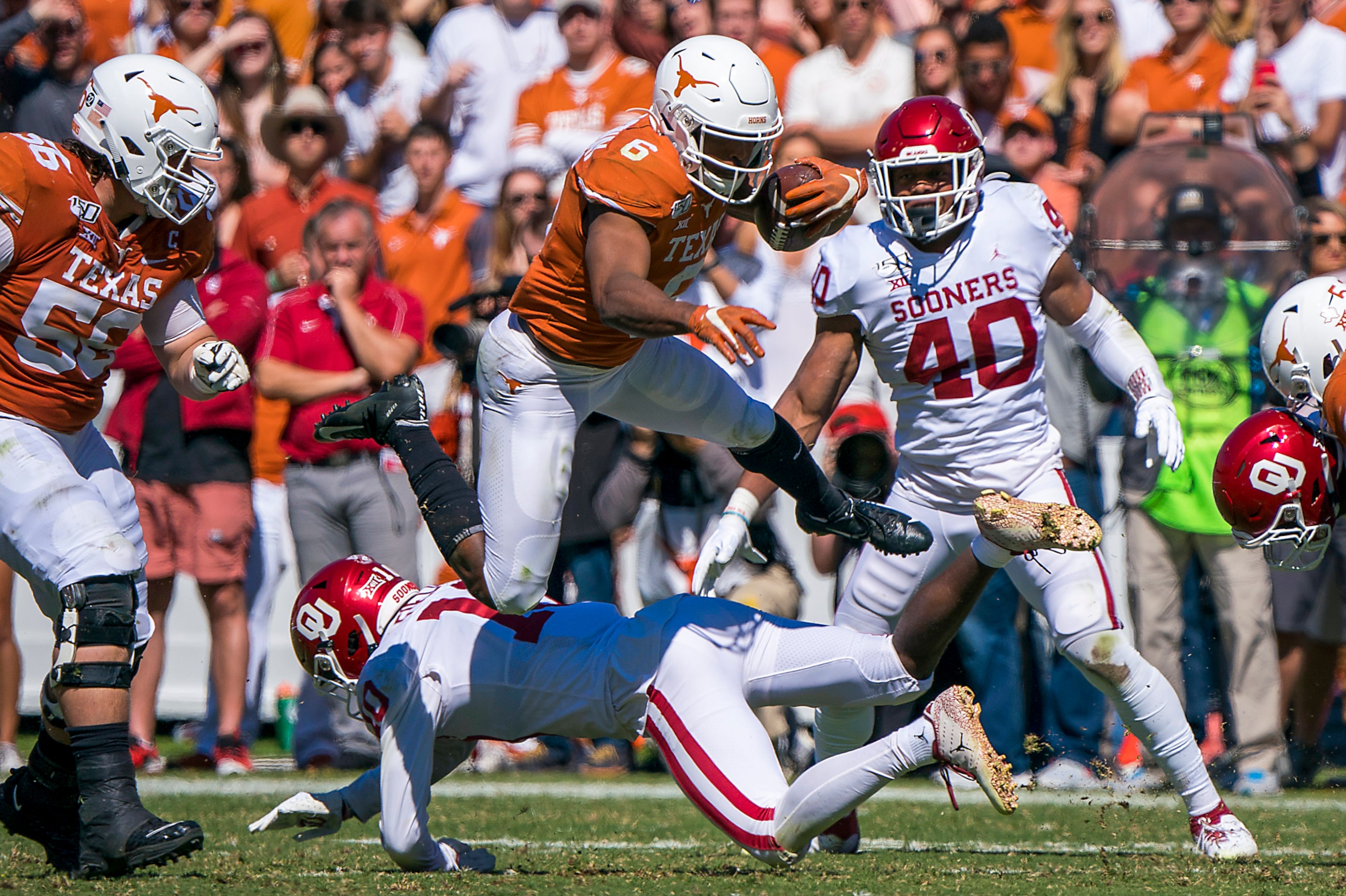 Texas wide receiver Devin Duvernay (6) leaps over Oklahoma safety Pat Fields (10) during the...