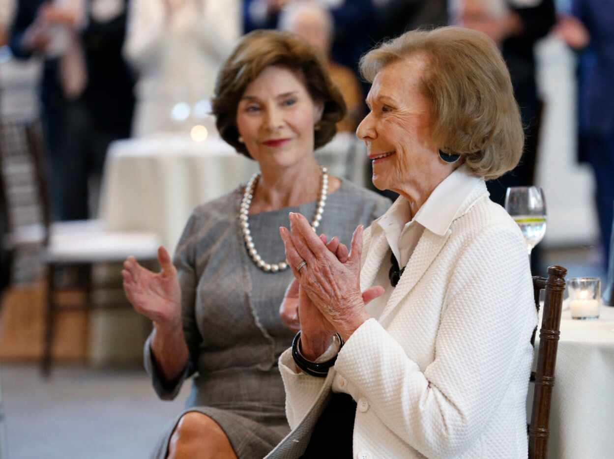 Philanthropist Ruth Altshuler reacts and former first lady Laura Bush looks on after...