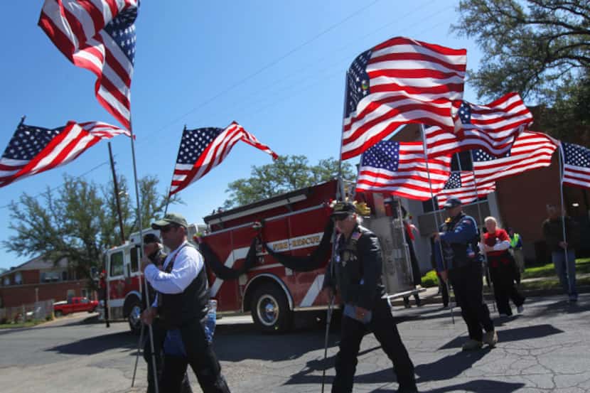 Members of the Patriot Guard Riders carried American flags and stood vigilant outside St....