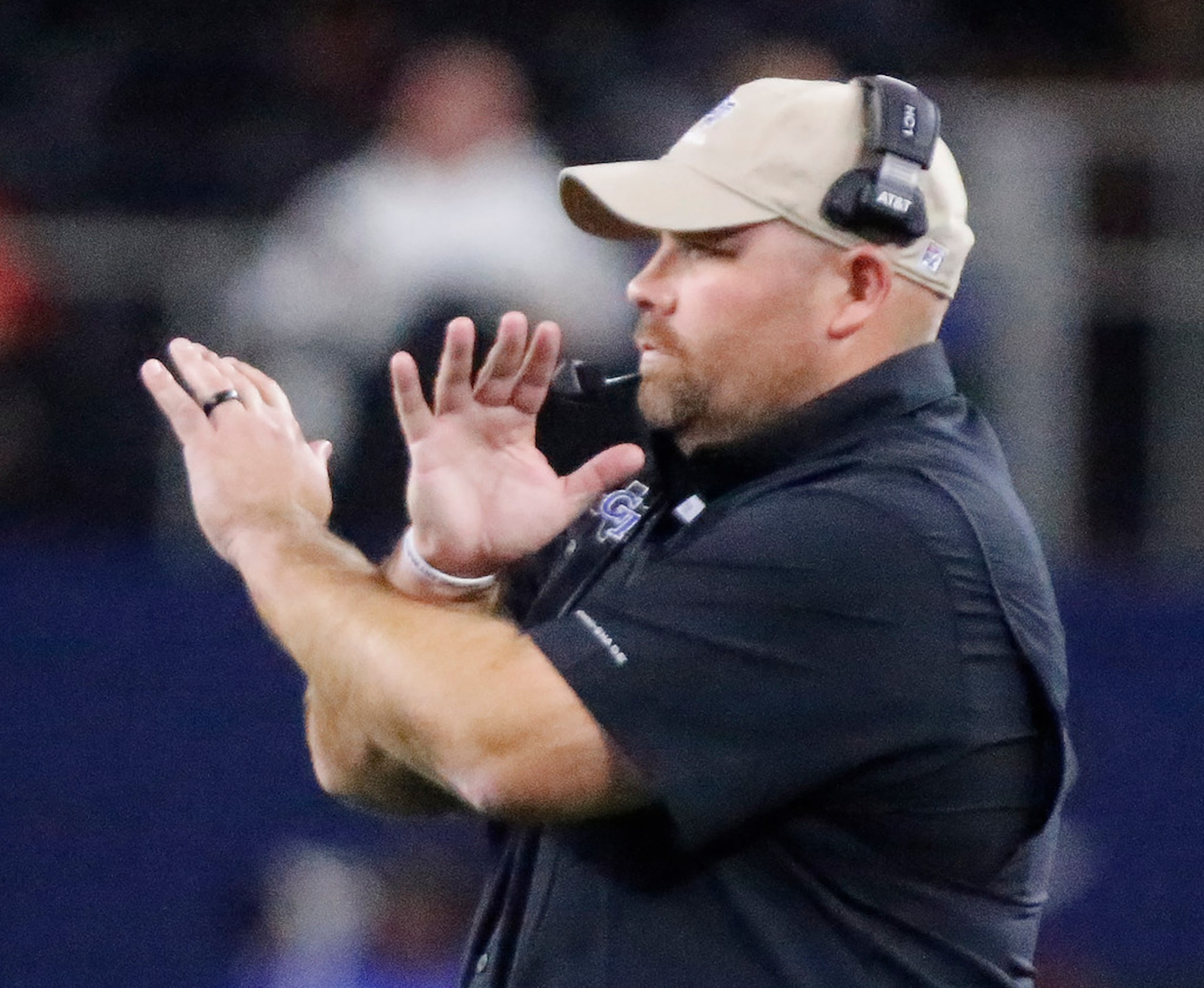 Gunter High School head coach Jake Fieszel signal in a defensive play during the first half...