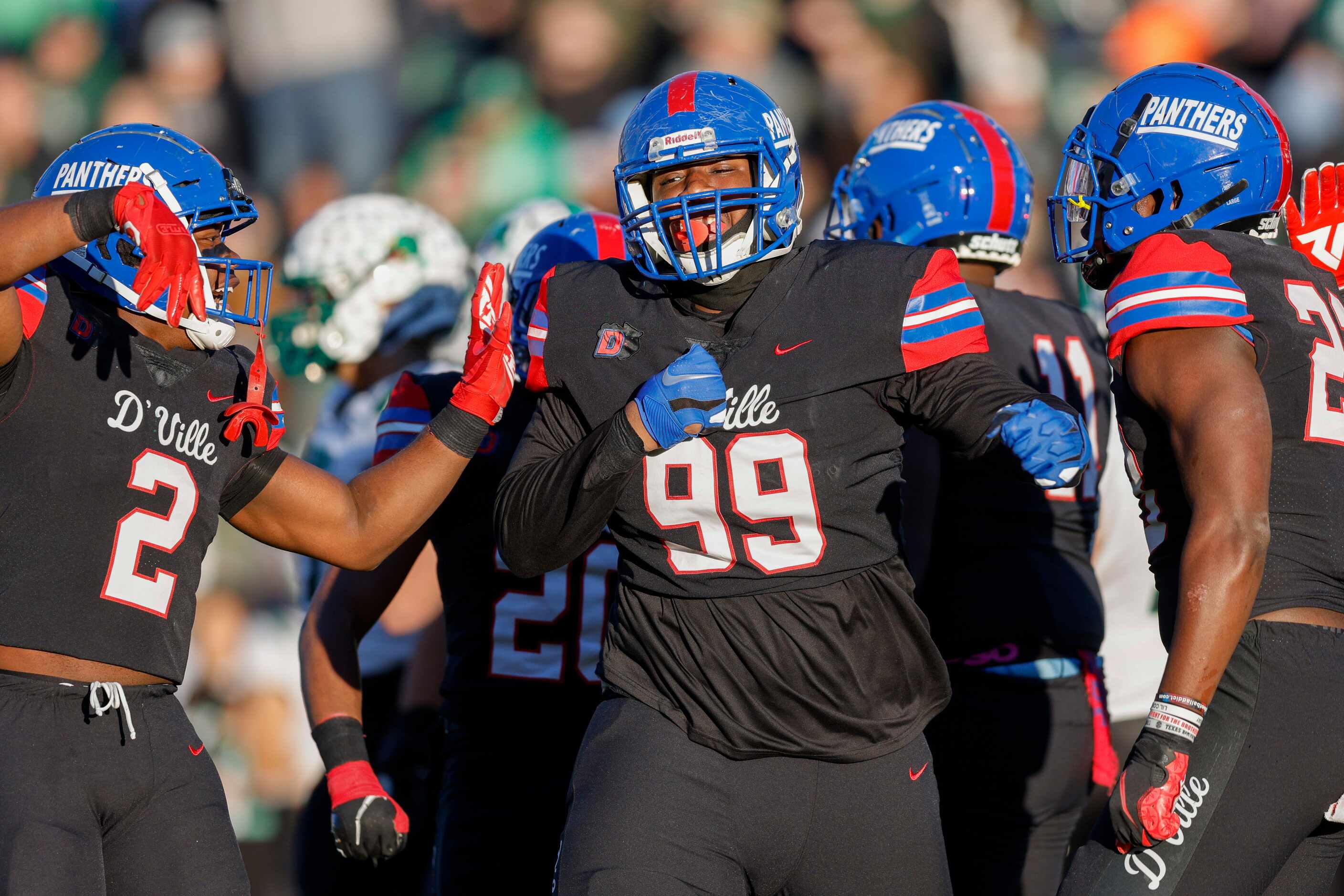 Duncanville defensive lineman Alex January (99) celebrates  after a tackle with linebacker...