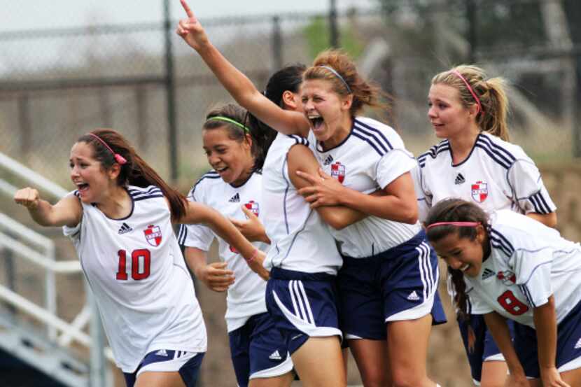Denton Ryan's Kirby Wright (16), center, celebrates with her teammates after hitting a goal...