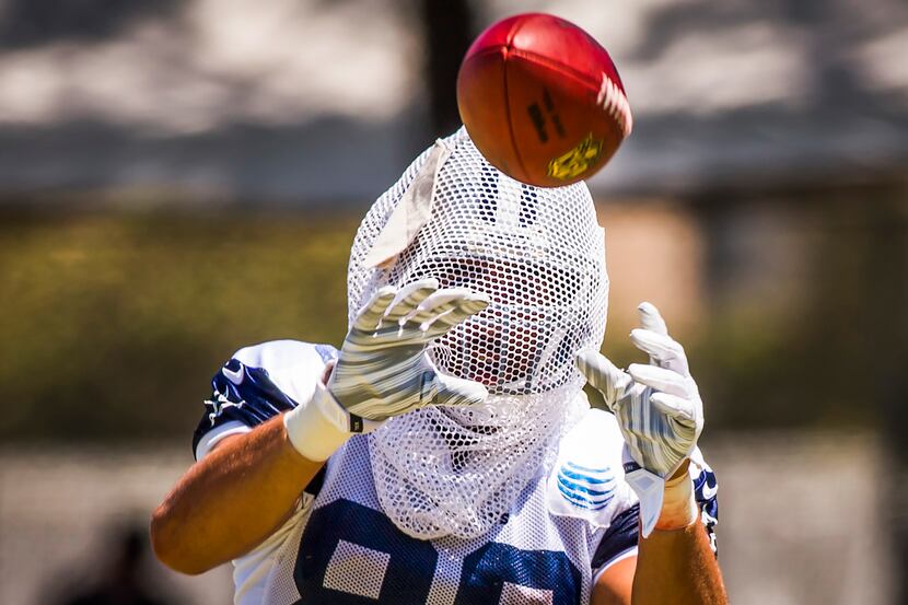 Dallas Cowboys tight end Gavin Escobar catches passes with a mesh bag over his head in a...
