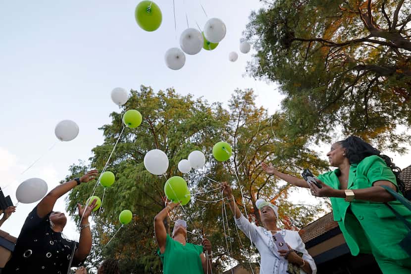 Isis Adger’s sister Makeya Adger of Coral Springs, Fla. from right, releases balloons in...