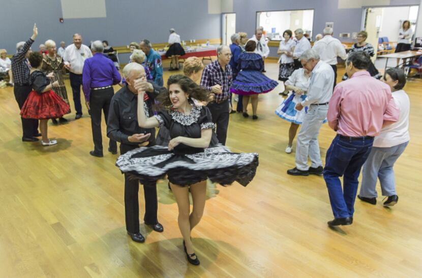 Amy McKinley twirls with dance partner George Johnson at the Dixie Chainers Square and Round...