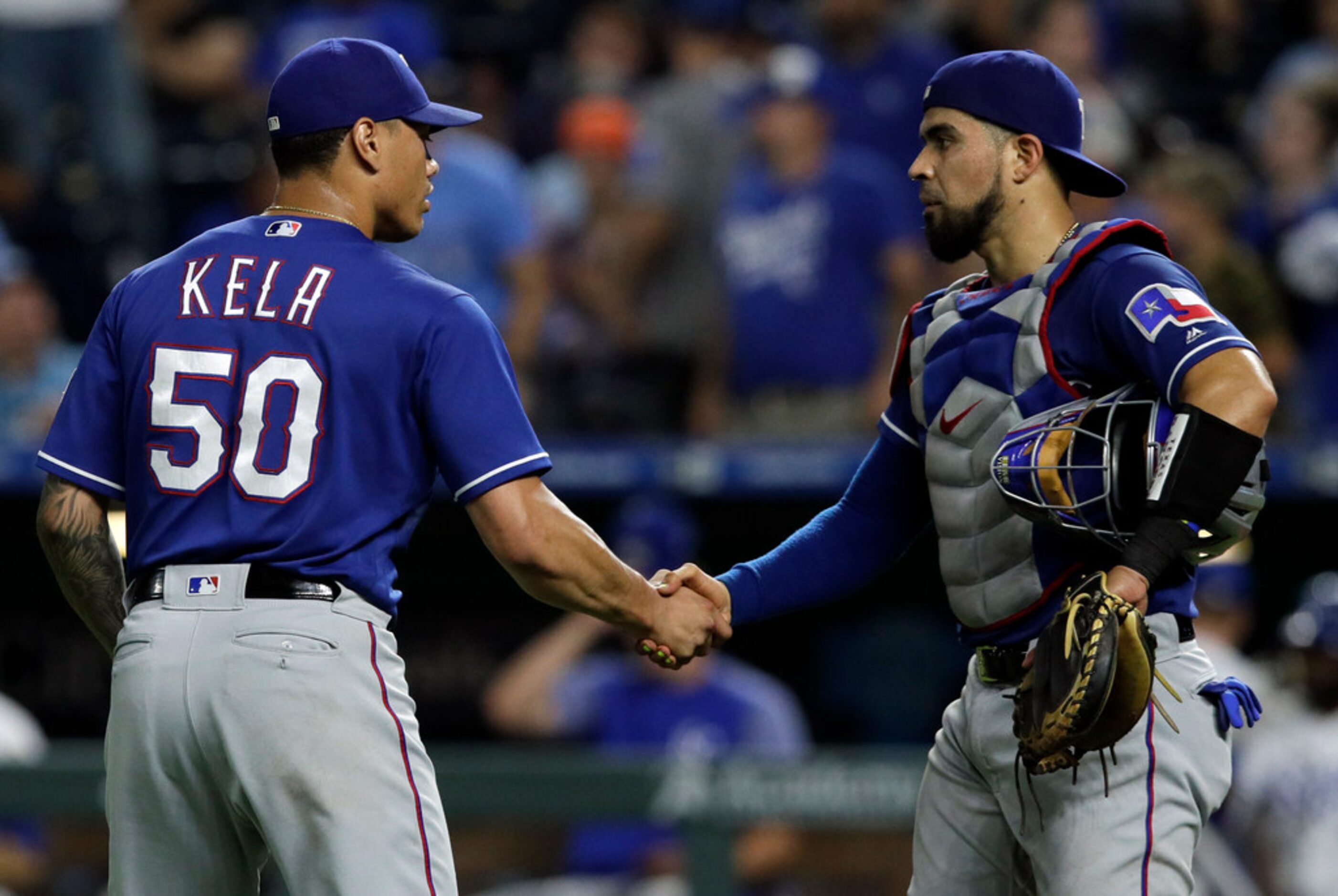 Texas Rangers relief pitcher Keone Kela (50) shakes hands with catcher Robinson Chirinos...