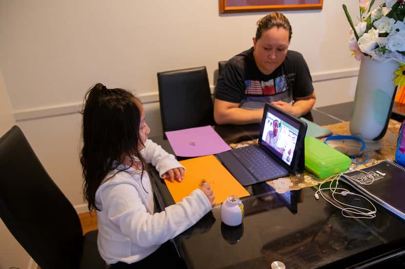 Adali Arriaza (right) watches as her daughter Daysha Cojulum, 5, attends her virtual class...