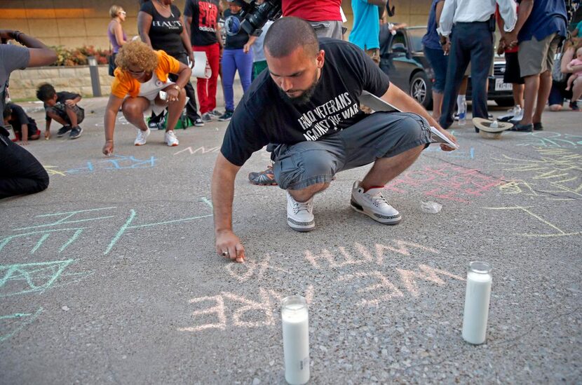 
Ramon Mejia joined other participants in a vigil Monday evening for Christian Taylor by...