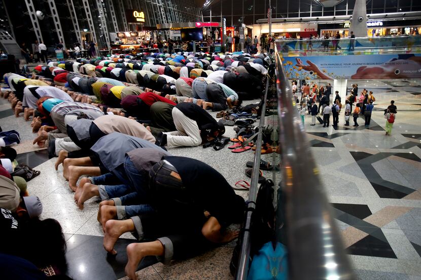 Muslim men offered prayers at Kuala Lumpur International Airport for missing Malaysia...