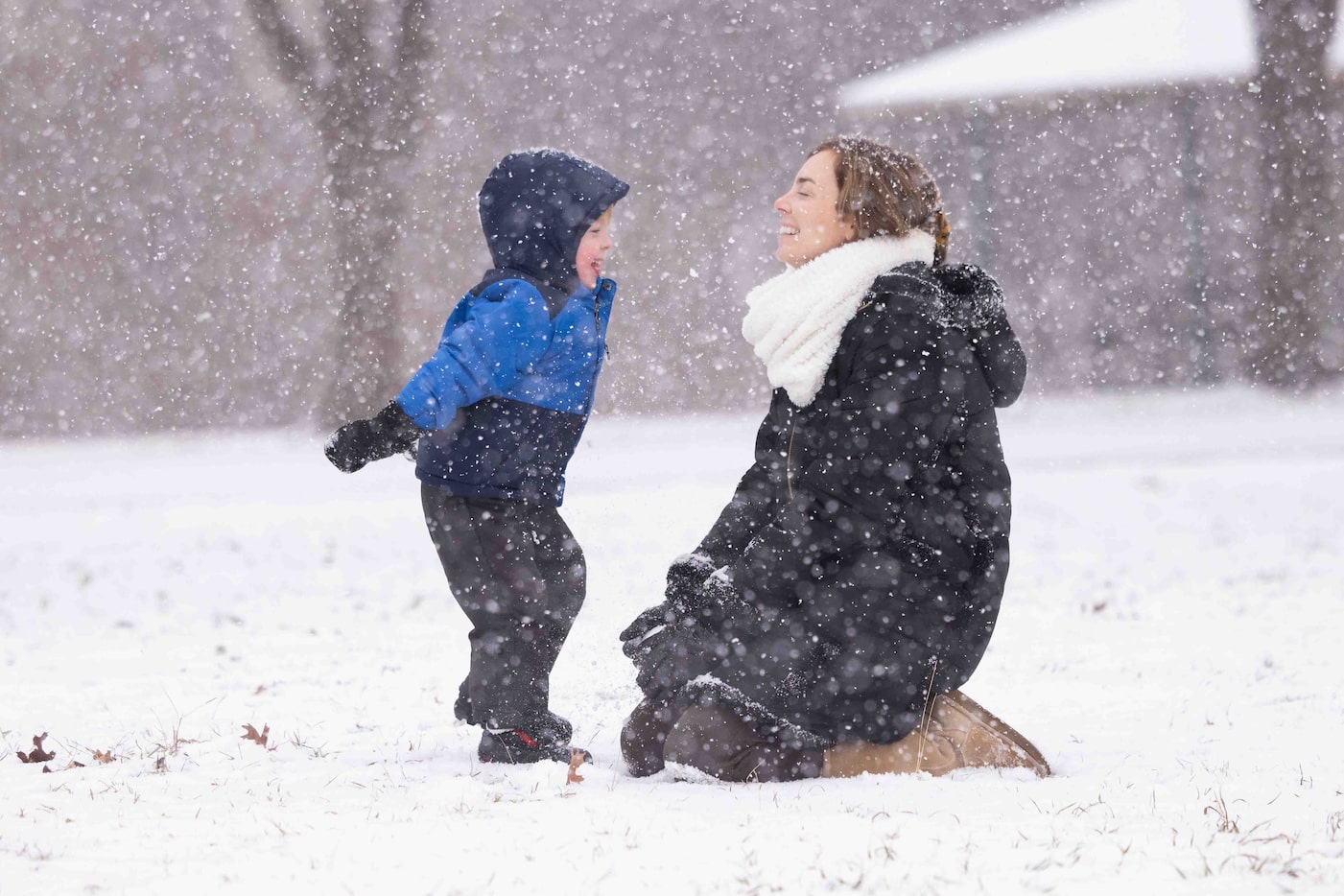 Ryan Talman, 2, enjoys the snowfall with his mom Katie Talman at Frankford Park in Dallas on...