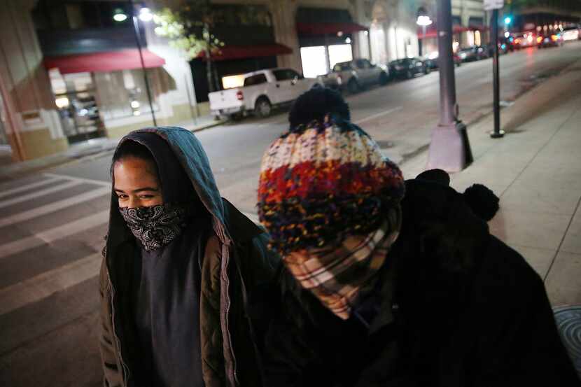 Floridians Nicole Ocasio (left) and her mother, Mari Ocasio, both of Tampa, bundled up while...