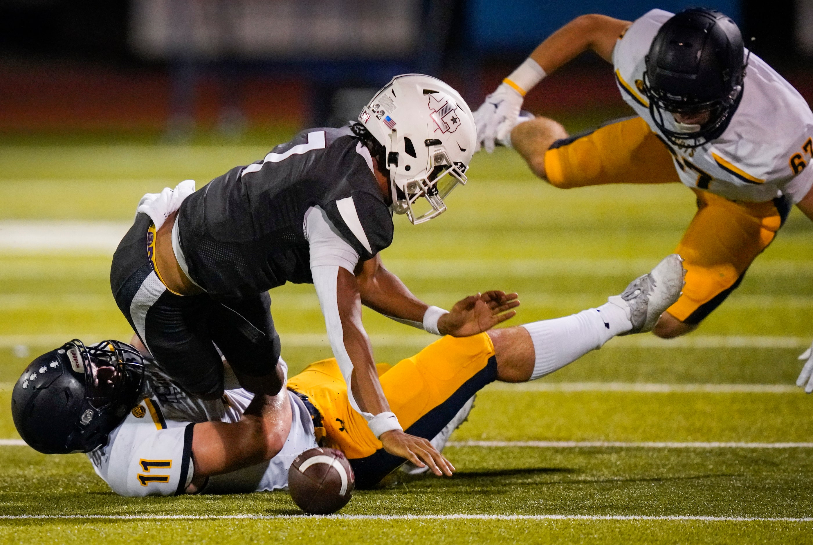 Lewisville quarterback  Ethan Terrell (7) loses the football as he is hit by Highland Park...