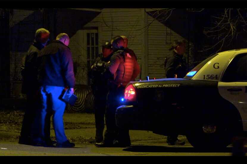 Fort Worth police officers investigate the scene of an officer-involved shooting at a home...