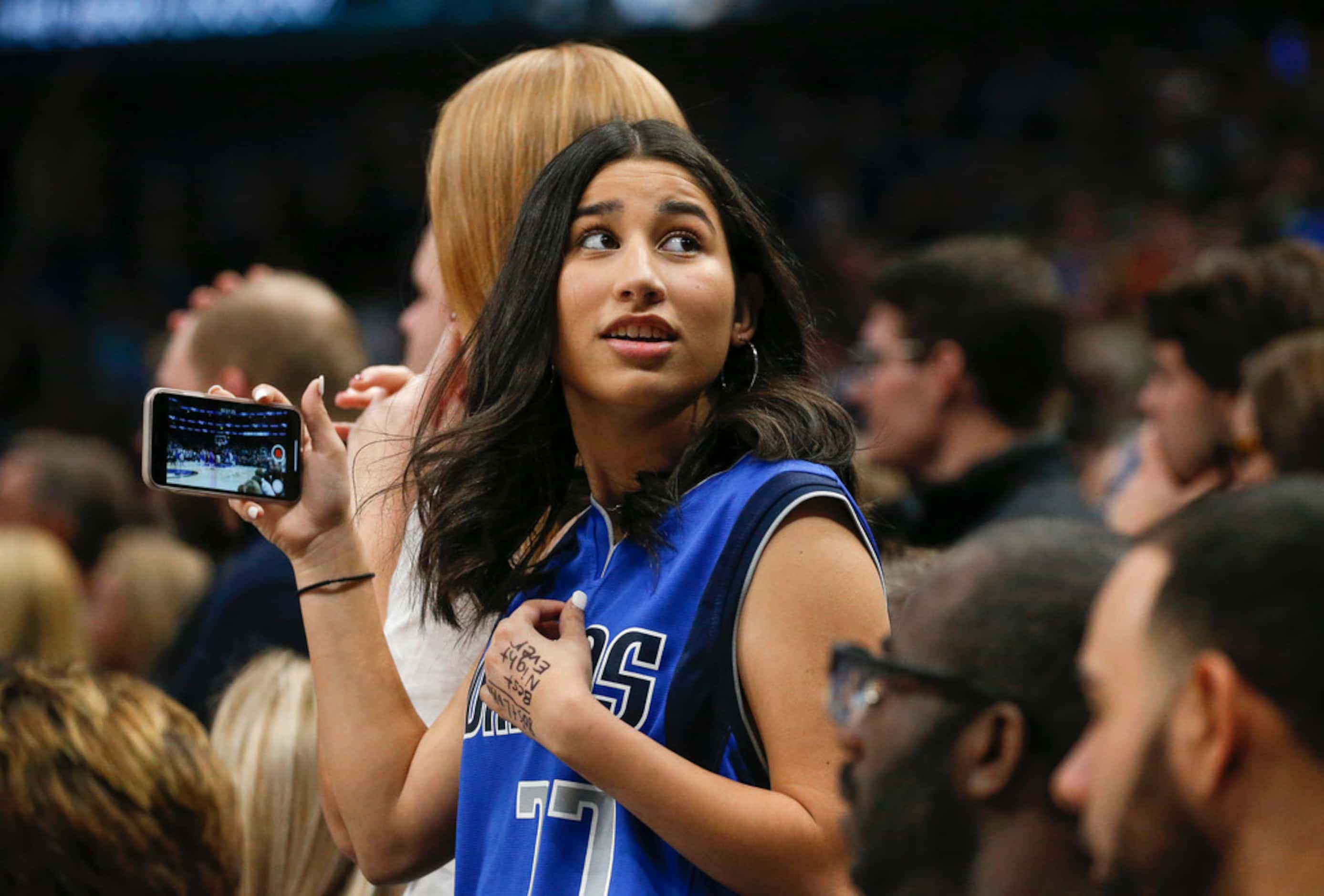 A Dallas Mavericks fan records the final moments of an overtime loss to the Charlotte...