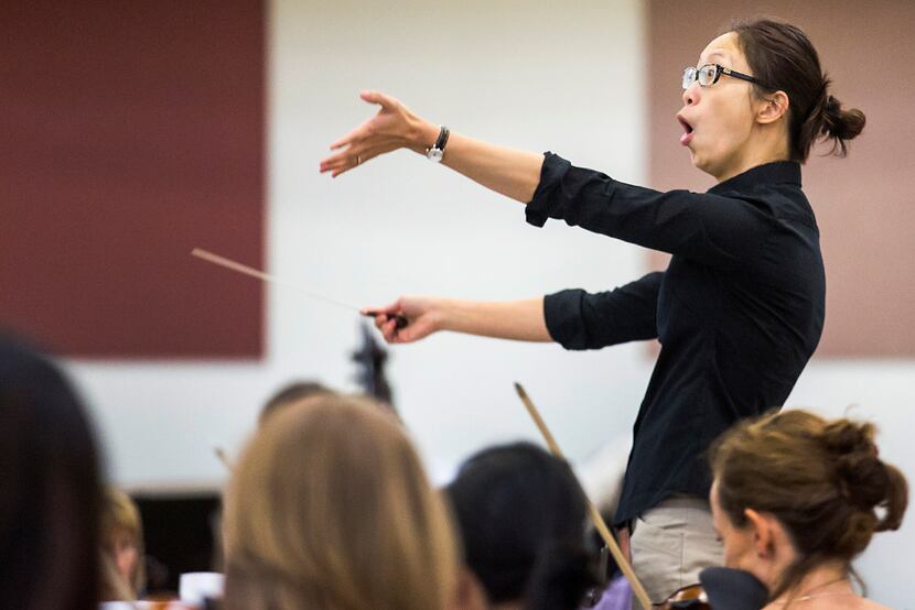Chaowen Ting conducts the Dallas Opera Orchestra in rehearsal during the Linda and Mitch...