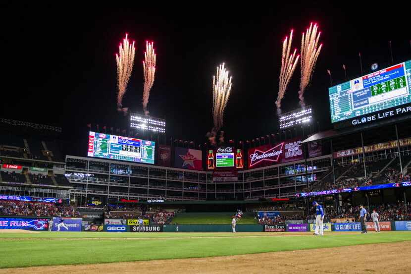Fireworks sparkle as Texas Rangers right fielder Shin-Soo Choo (17) runs the base after...