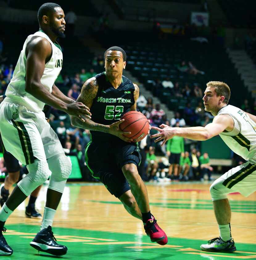 North Texas junior guard J-Mychal Reese (52) drives between Charlotte senior center Joseph...