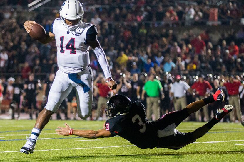 Allen quarterback Grant Tisdale (14) jumps over the arm of Coppell defensive back Jonathan...