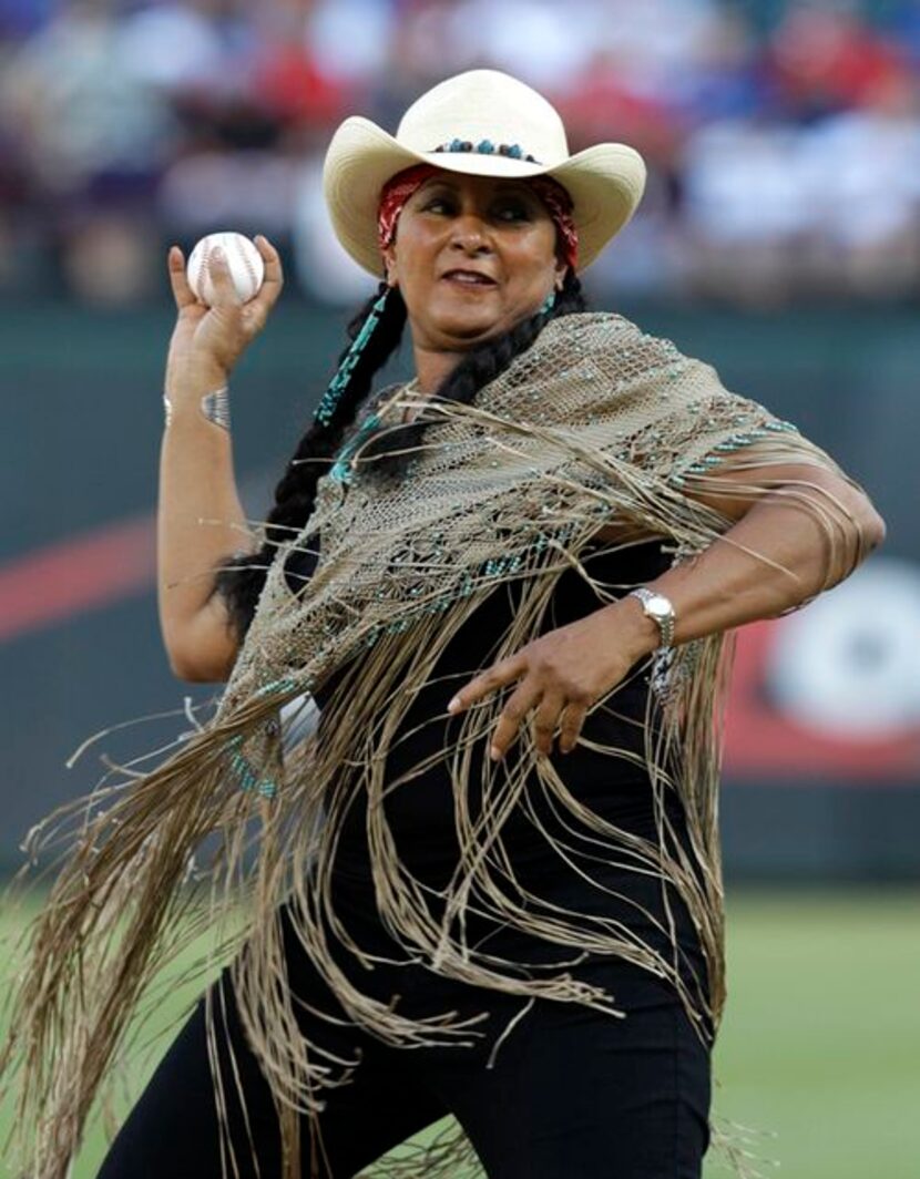 Actress Pam Grier throws out the ceremonial first pitch before a baseball game between the...