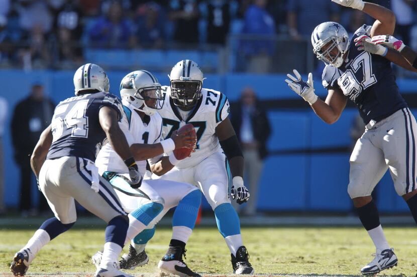 FILE - Carolina Panthers quarterback Cam Newton (1) is pressured by Dallas Cowboys inside...