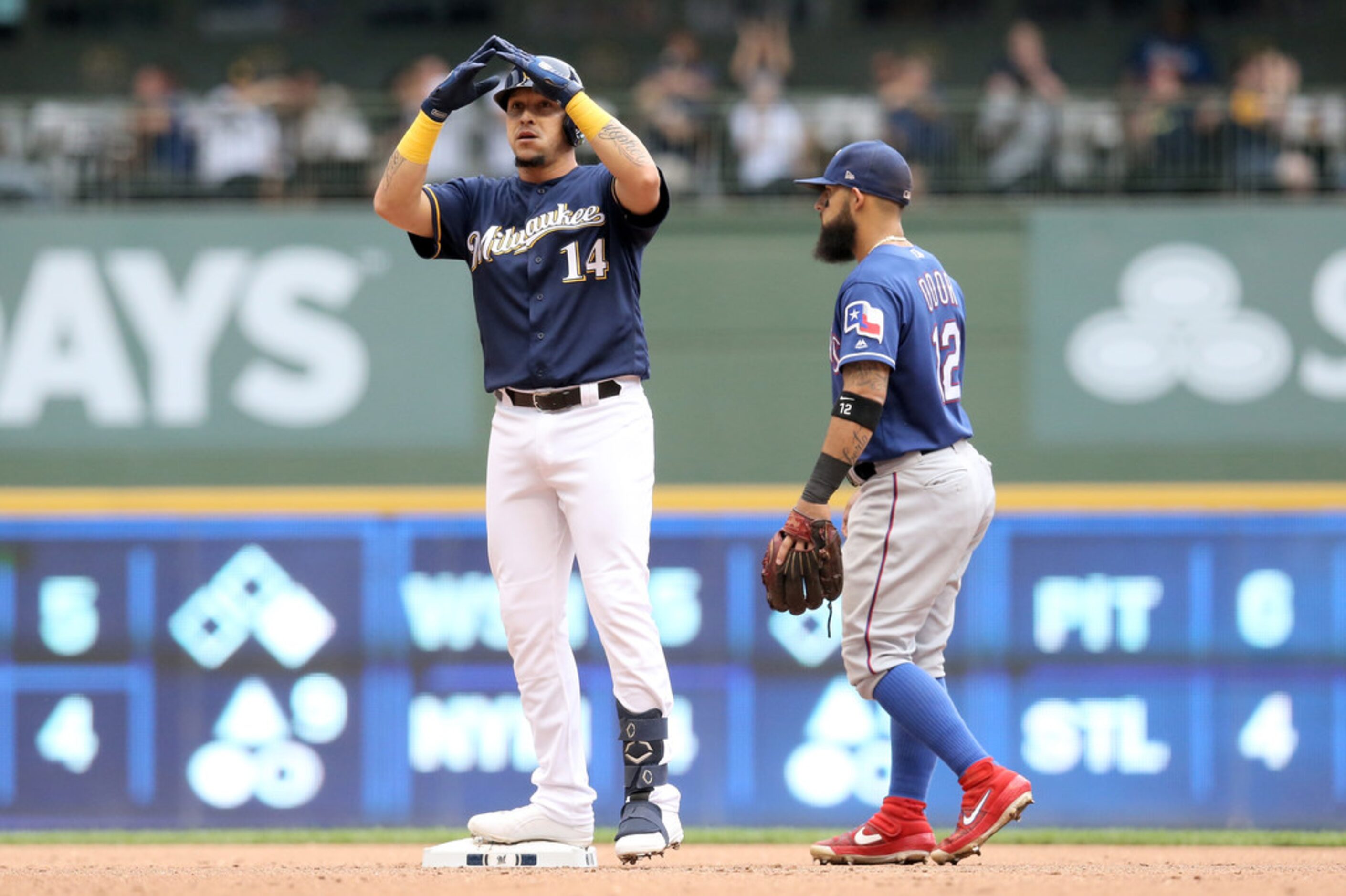 MILWAUKEE, WISCONSIN - AUGUST 11:  Hernan Perez #14 of the Milwaukee Brewers celebrates...