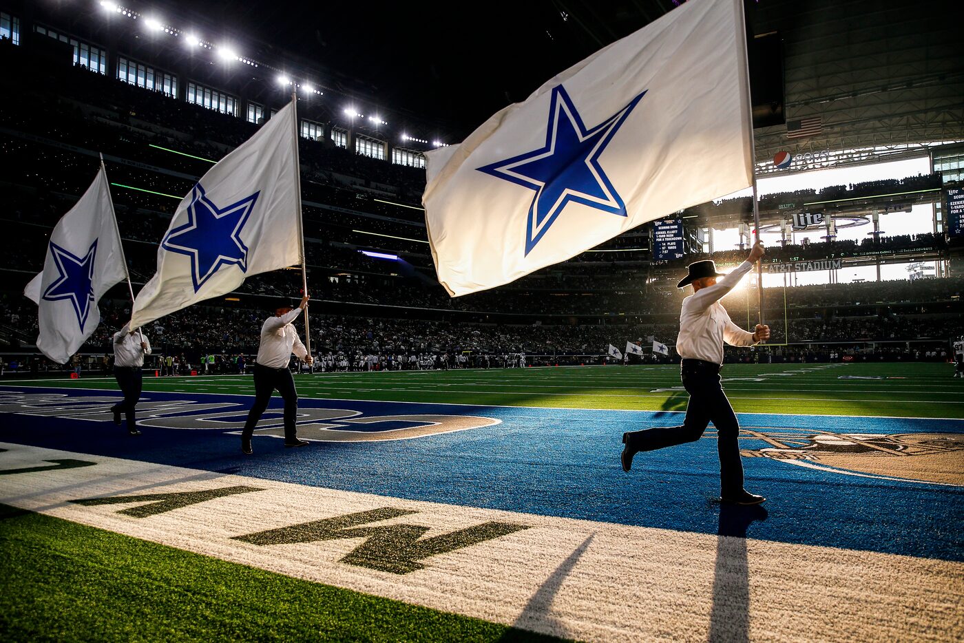 The Dallas Cowboys flag team flies through the end zone following a first half touchdown in...