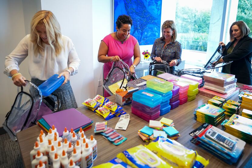 From left: Ali Ledbetter, Selena Underwood, Emily Durante and Mandy Moss help fill backpacks...