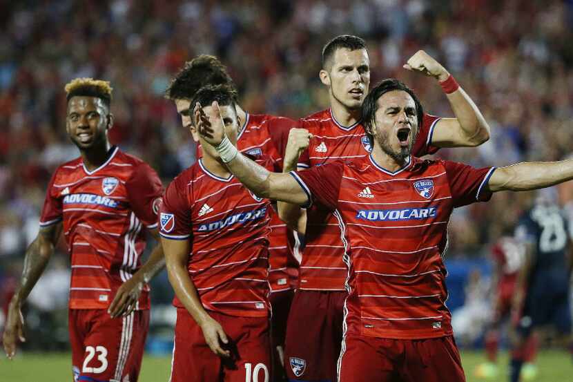 FC Dallas defender Matt Hedges (24), second to right, celebrates with teammates after...