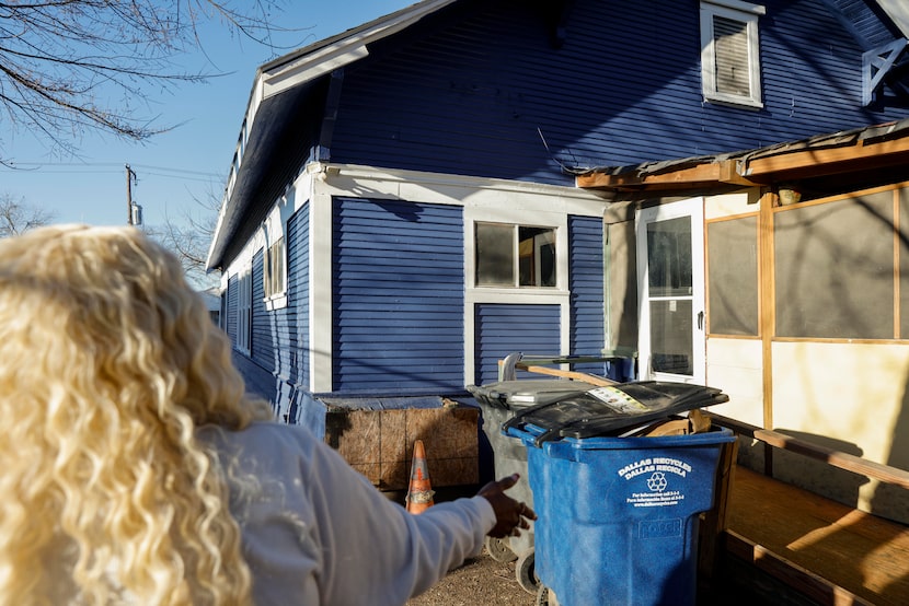 Zabrina Chism, 54, points to work that was left incomplete by contractors with the city of...