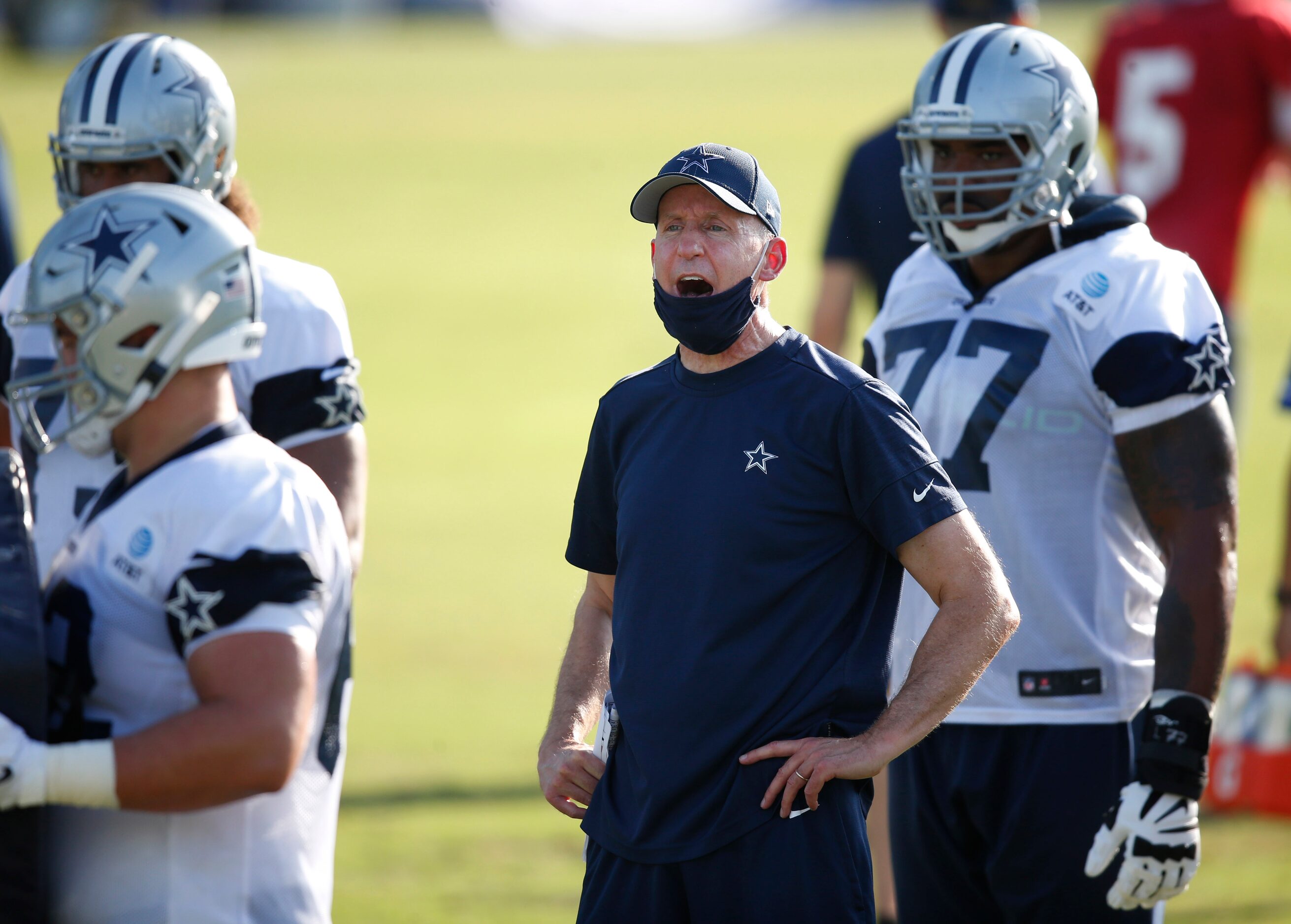 Dallas Cowboys offensive line coach Joe Philbin talks to a player during the first day of...