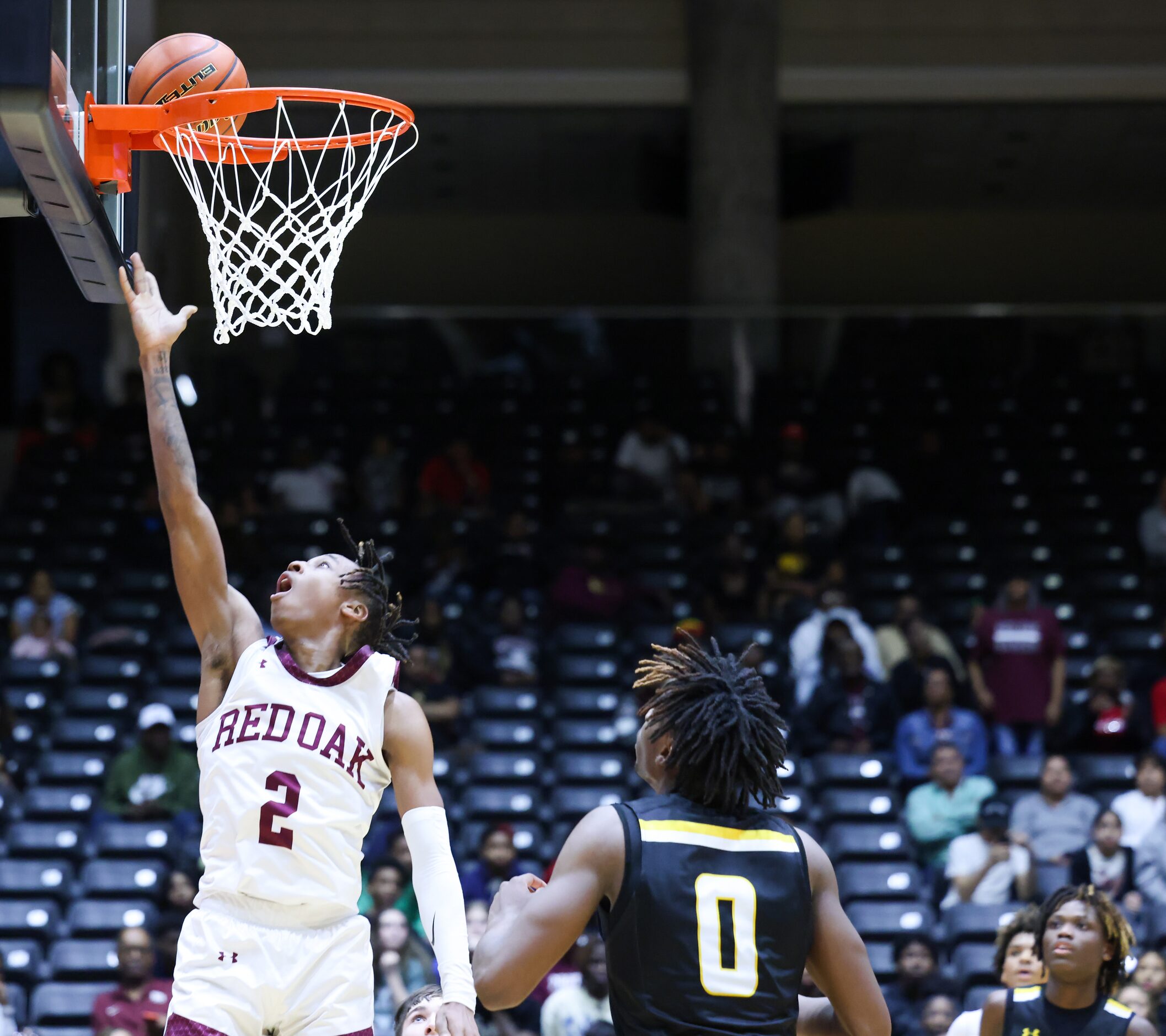 Red Oak senior guard Jayden Murphy (2) attempts a two-point shot in the final minutes of a...