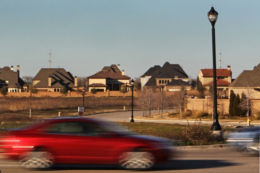 
Traffic zooms by on Eldorado Parkway as a subdivision rises on the horizon in Frisco.
