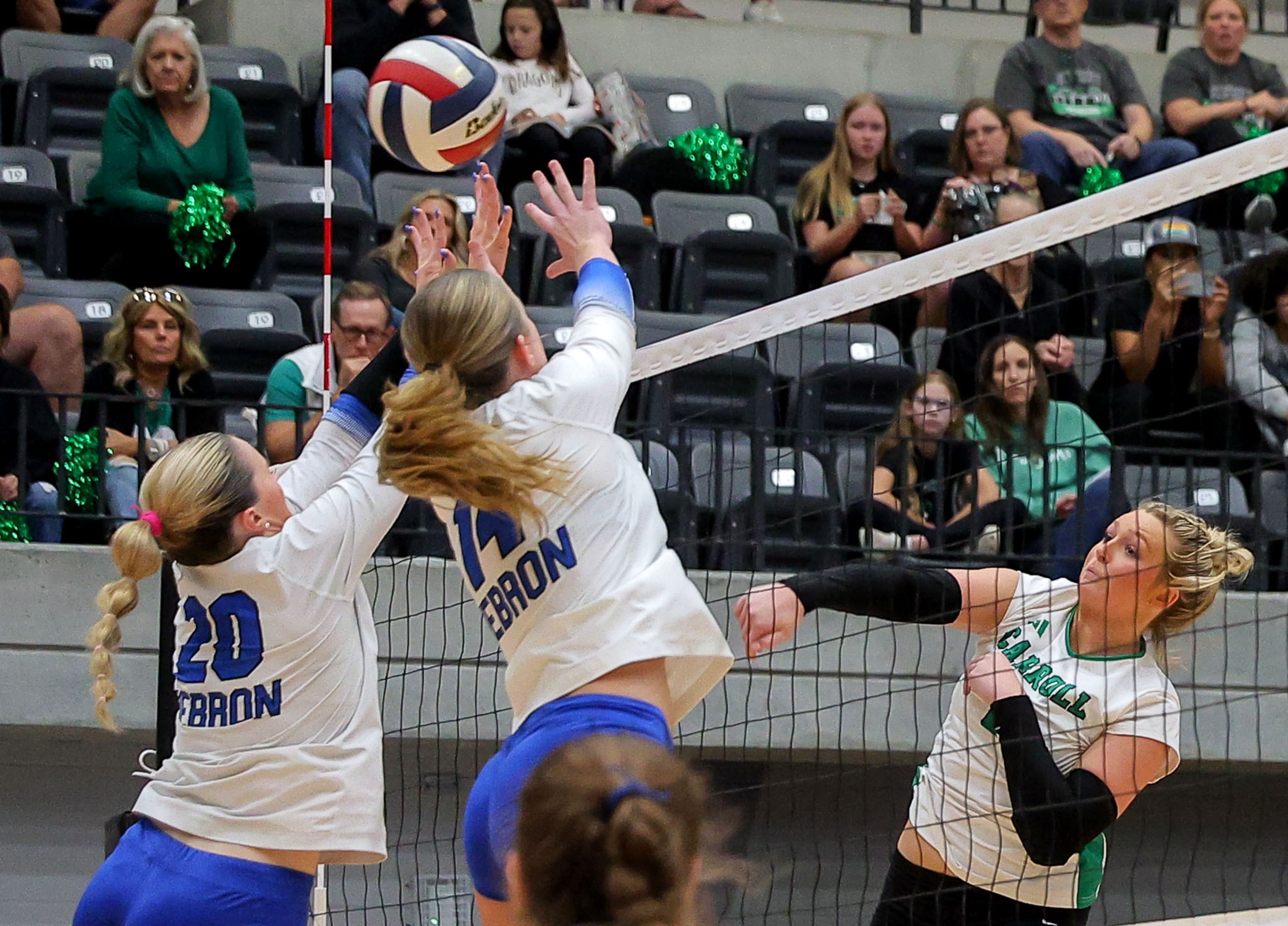 Southlake Carroll's Mary Beth Morse (6) gets kill past Hebron's Haley Kerstetter (14) and...