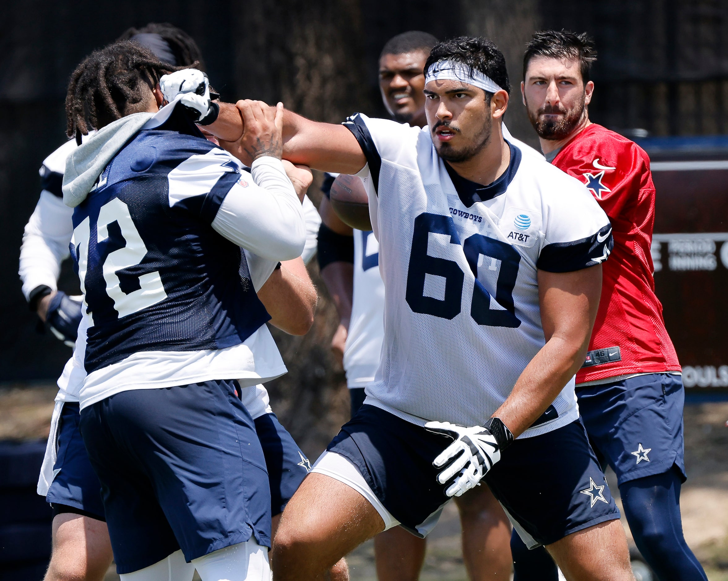 Dallas Cowboys offensive tackle Isaac Alarcon (60) gets a stiff arm on defensive tackle...