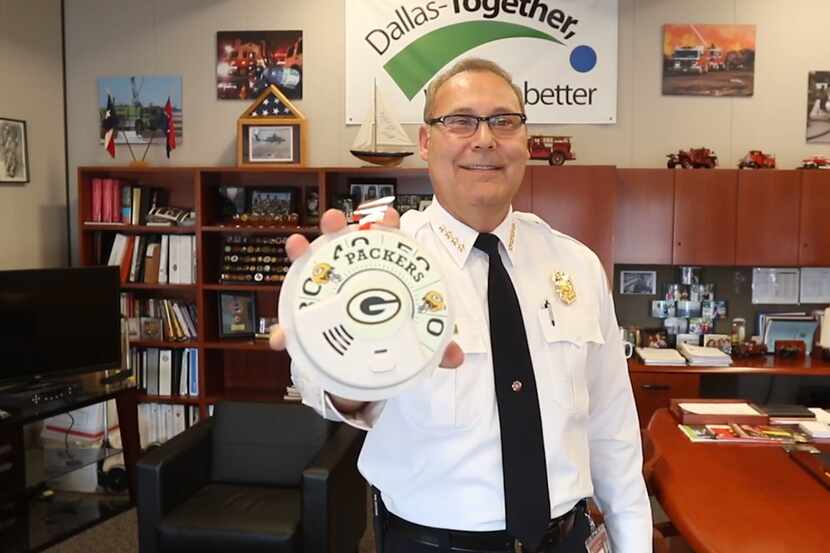 Dallas Fire Chief David Coatney lost a bet and must install a Green Bay Packers smoke alarm...