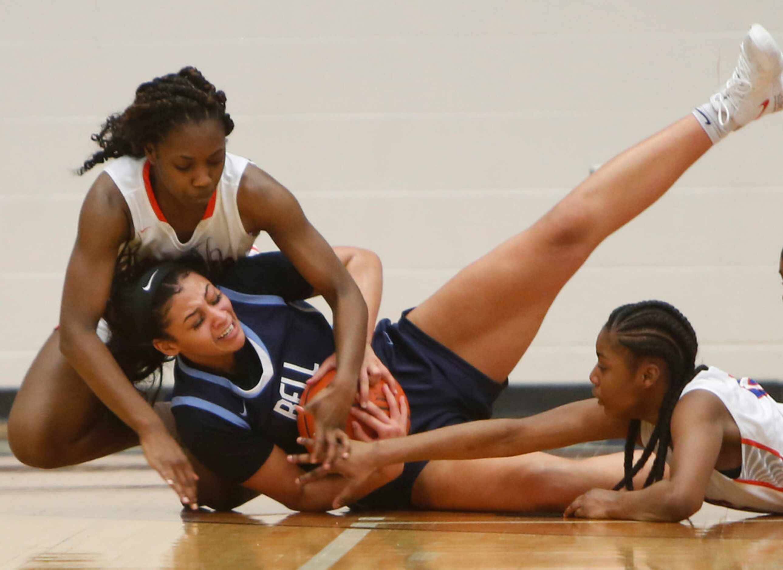 Hurst L.D. Bell guard Myra Gordon (15) wraps up the ball to protect it from Arlington Bowie...
