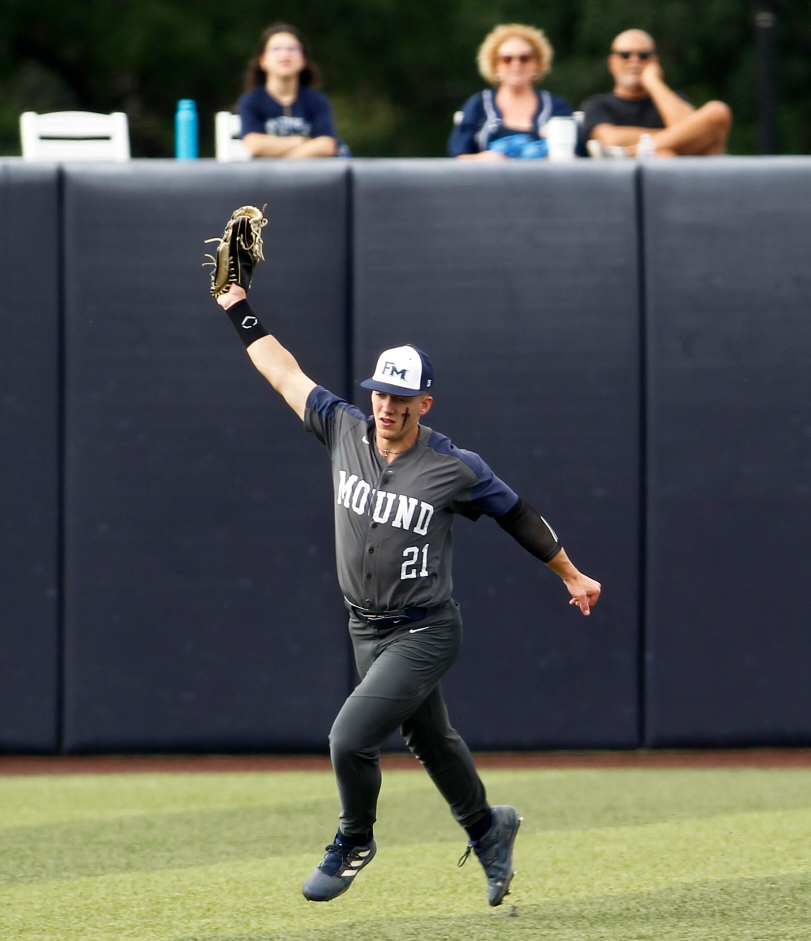 Flower Mound center fielder Sam Erickson (21) extends to catch a fly ball to retire a Keller...