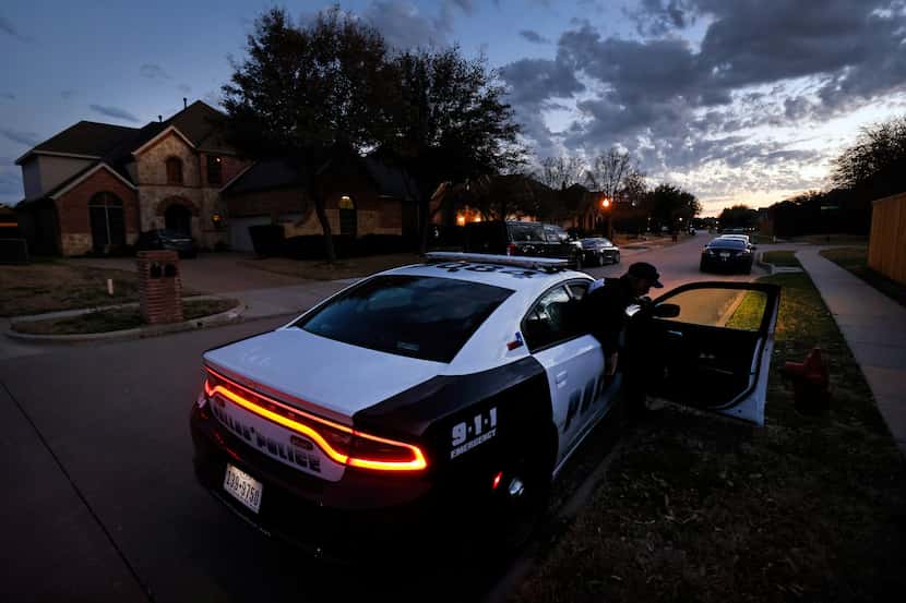 Dallas Police sit outside Eboni Samuel and Bryan Riser's home as an FBI Evidence Response...