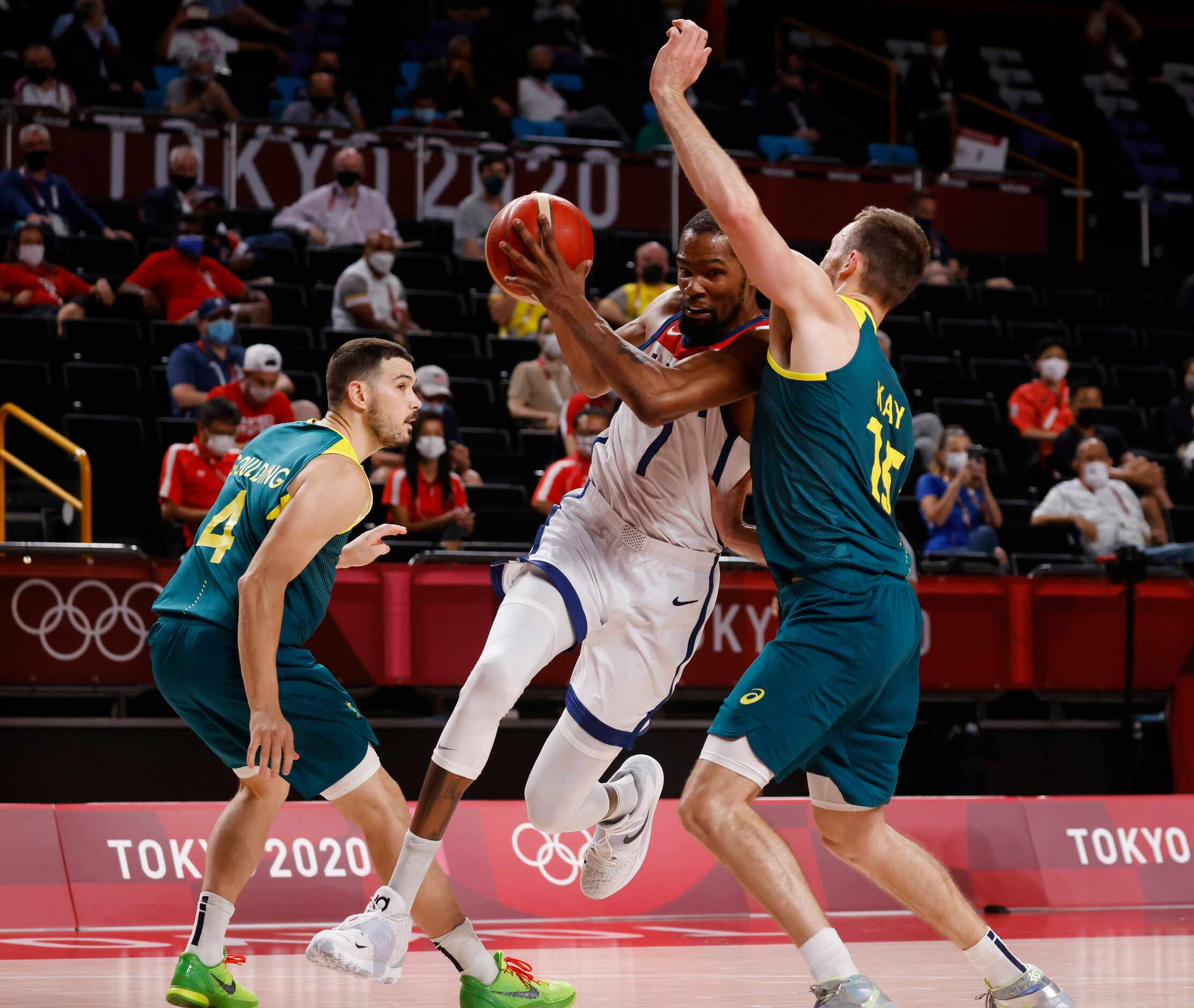 USA’s Kevin Durant (7) splits Australia’s Chris Goulding (4) and Nic Kay (15) on his way to...