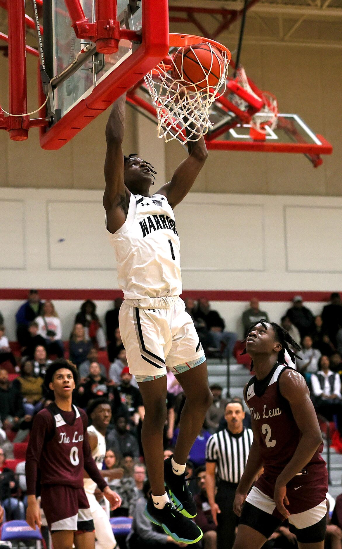 Arlington Martin guard Jeremiah Charles slams home two poins against Lewisville during the...