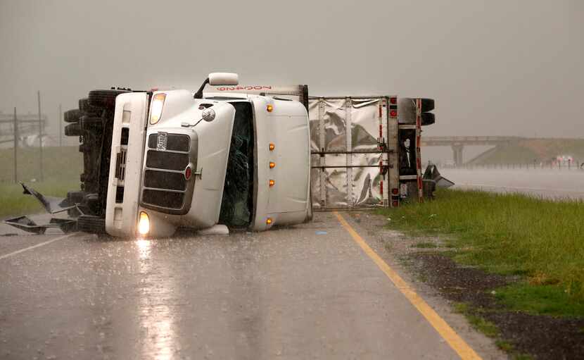 Overturned trucks blocked a frontage road off Interstate 40 just east of U.S. Highway 81 in...