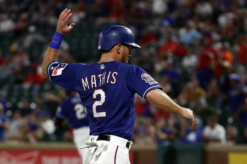 ARLINGTON, TEXAS - AUGUST 21:  Jeff Mathis #2 of the Texas Rangers scores a run against the...