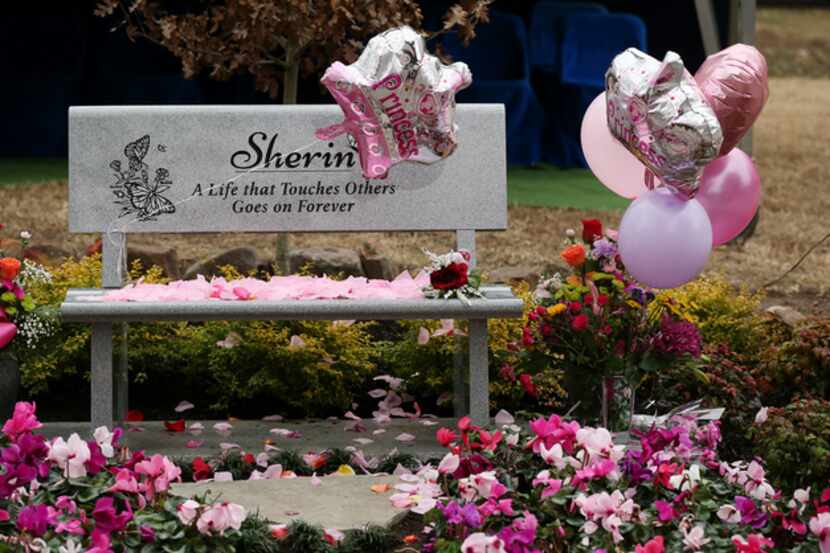 A granite bench in memory of 3-year-old Sherin Mathews was covered in rose petals left by...