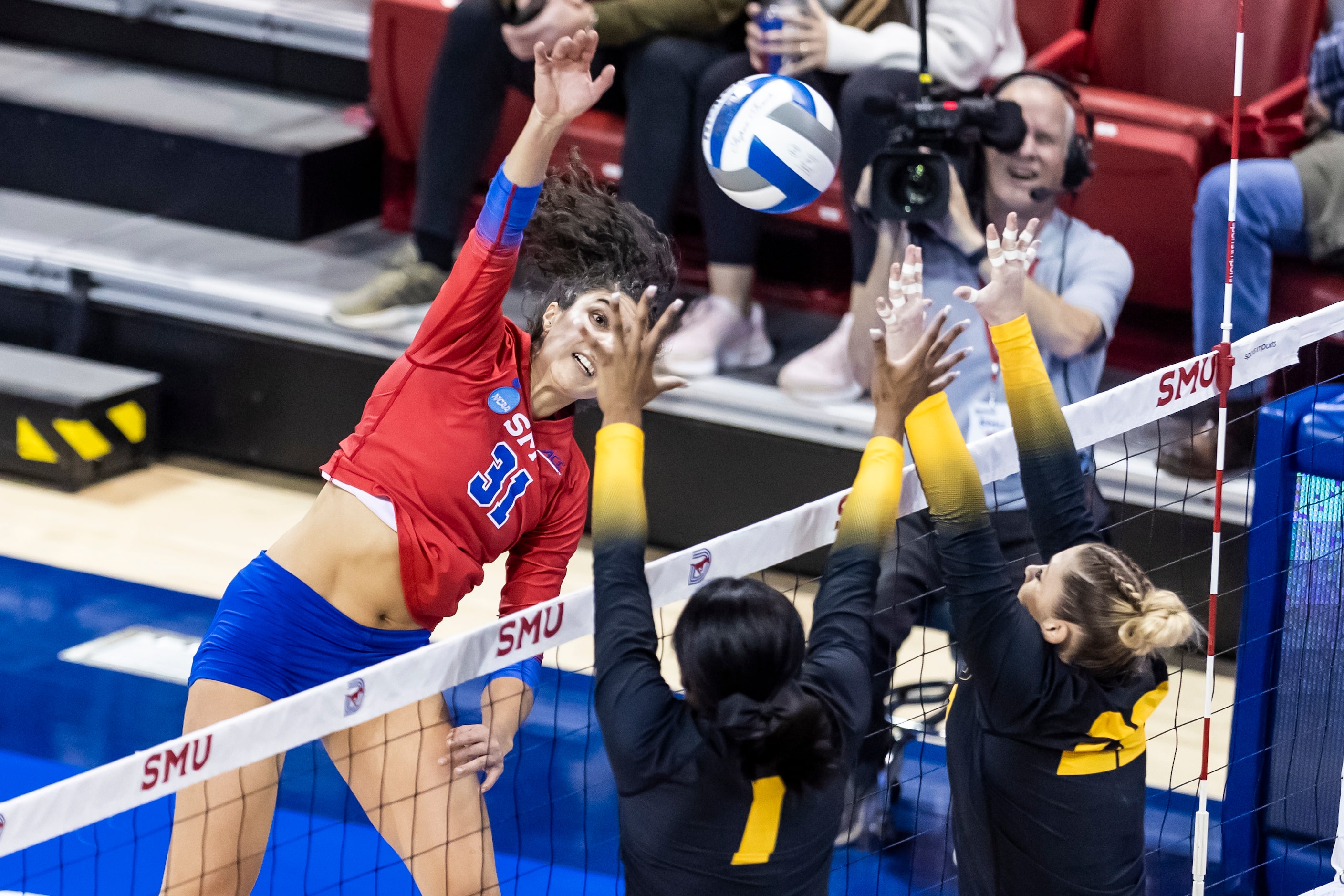 SMU’s Maya Tabron (31) spikes the ball as Missouri’s Colleen Finney (1) and Marina Crownover...